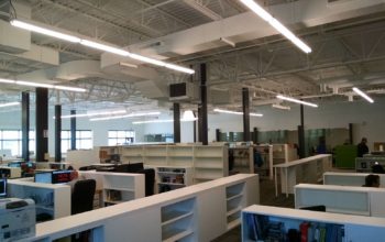 A shot of the new office. Glass-front offices (far wall) and windows behind the photographer keep everything open.