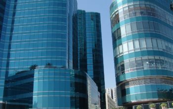 Cladding is the "skin" of a building. In recent yeas, many tall buildings have used reflective, tinted glass.