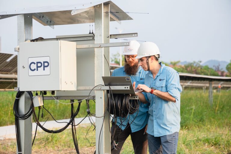 Wind Technicians Check Data on a Solar Array Installation