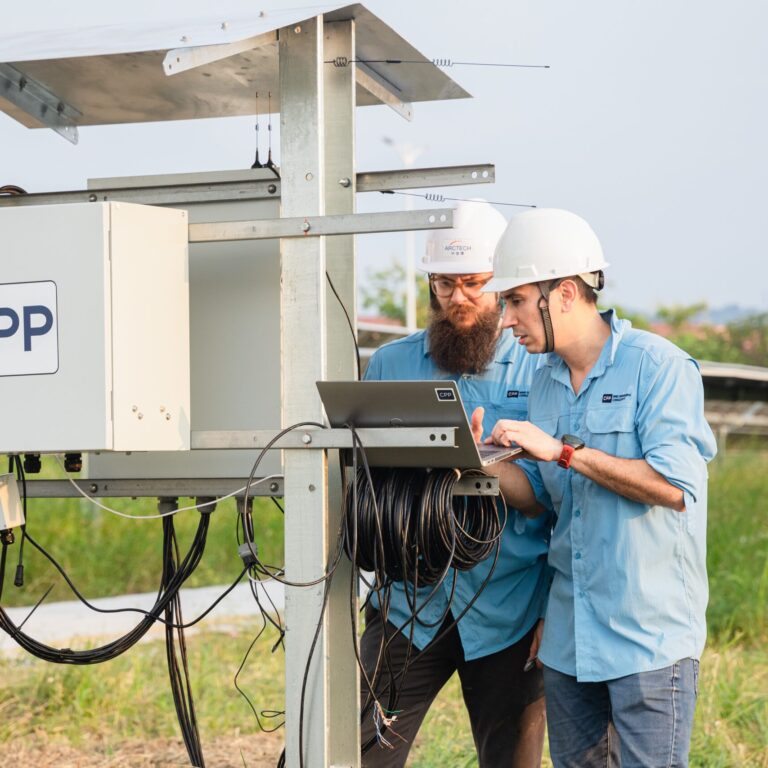 Wind Technicians Check Data on a Solar Array Installation
